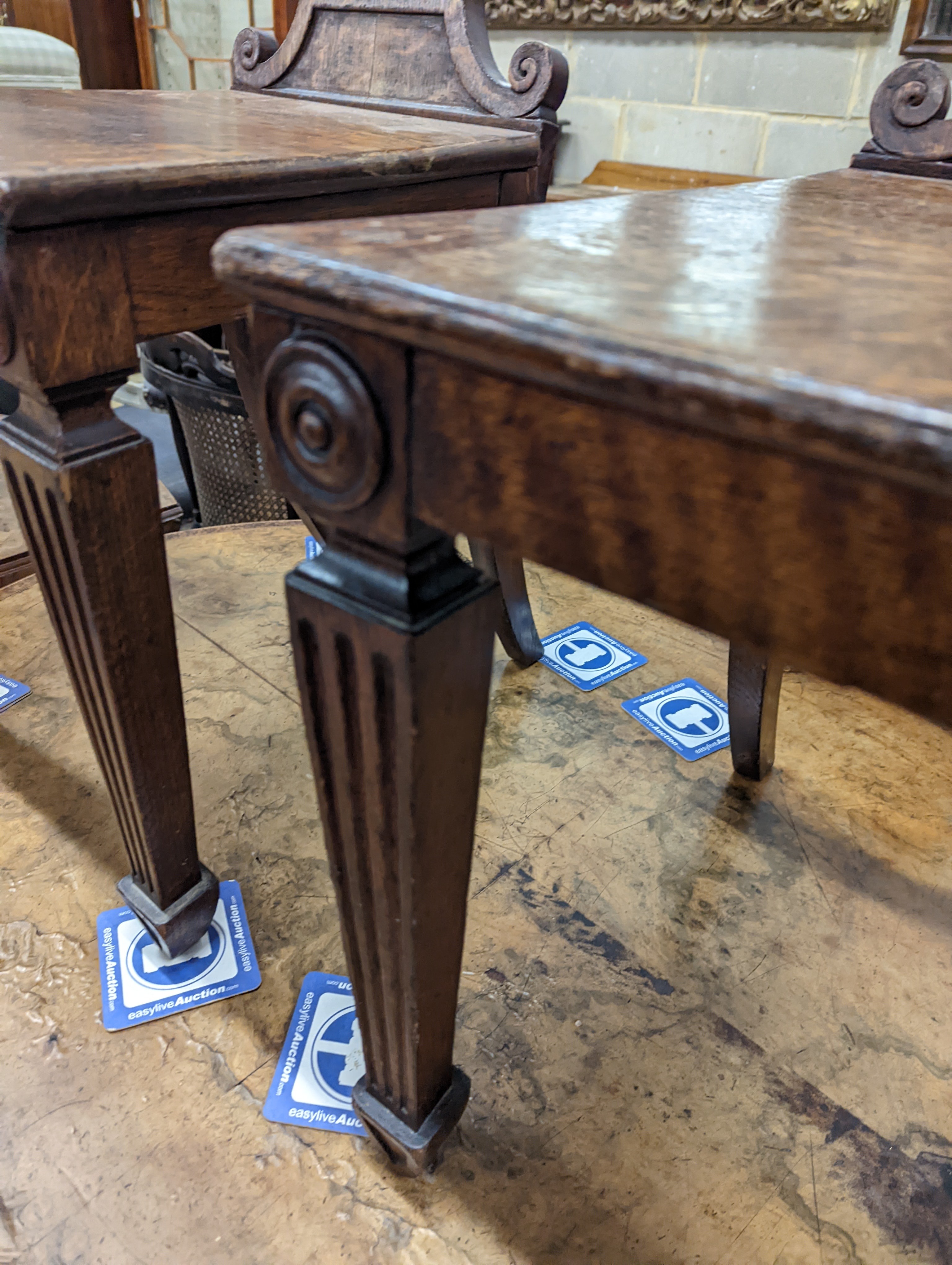 A pair of Victorian oak hall chairs with painted armorials, width 43cm, depth 39cm, height 94cm